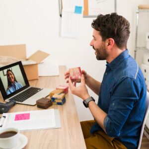 a business owner chatting on a laptop with a person