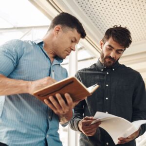 people looking at paperwork and taking notes