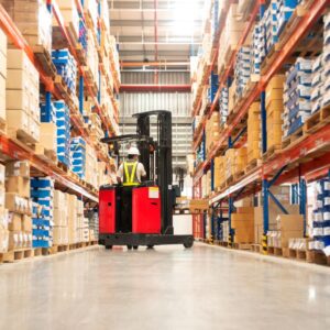 A forklift being driven in a warehouse