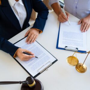 Two people reading over legal documents on clipboards