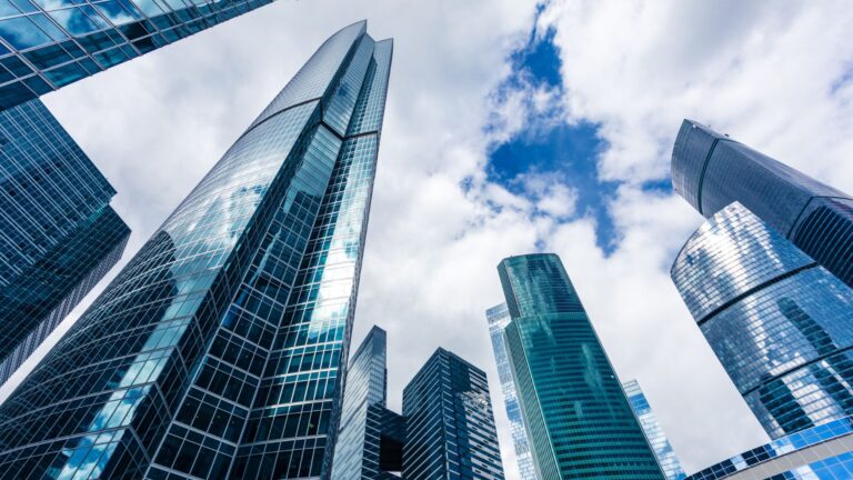 A view from below looking up at corporate buildings